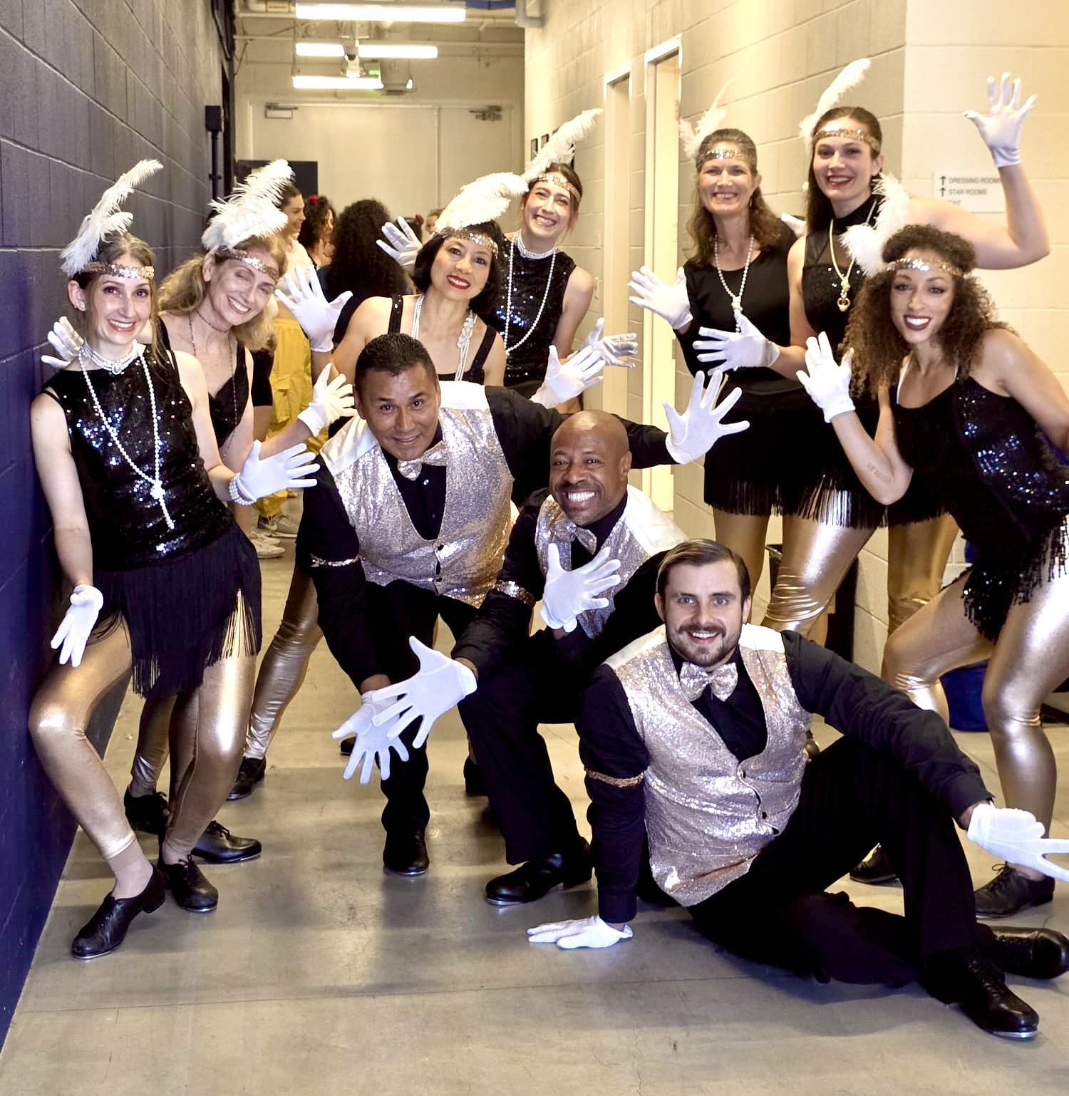 Tap dancers in flapper costumes backstage